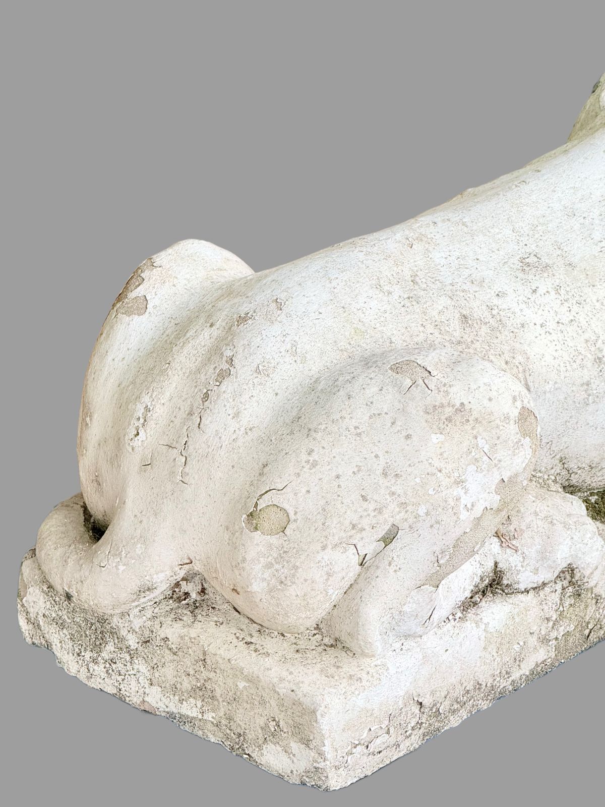 Close-up of cast stone lion haunch and base