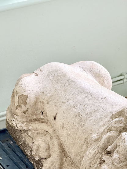 Close-up of weathered haunch on cast stone lion