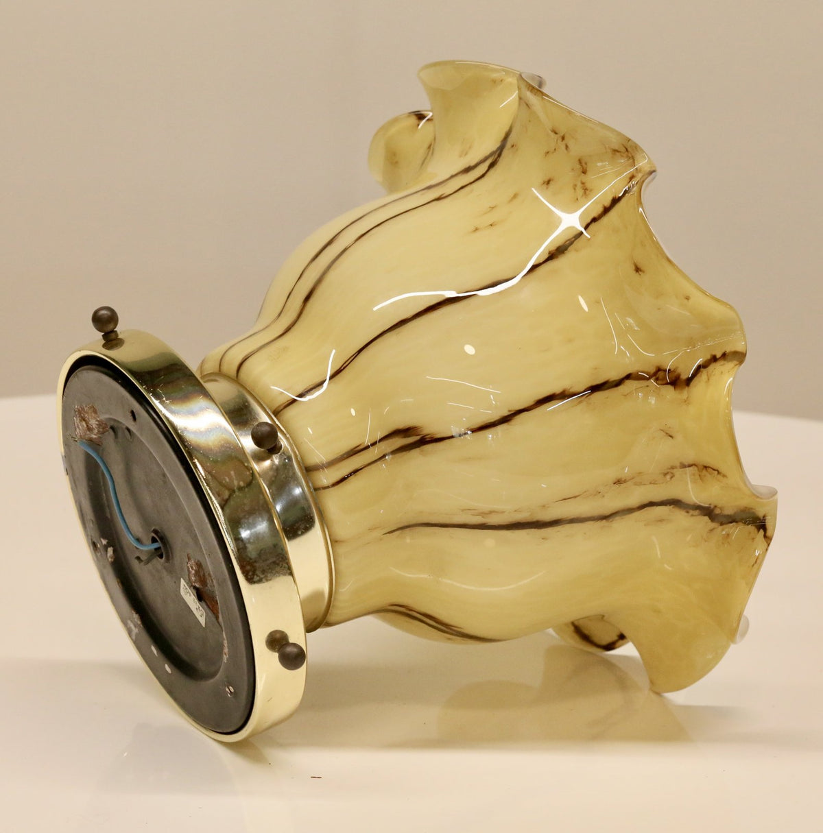 Peill & Putzler ruffled glass ceiling light laid on its side, brass backplate