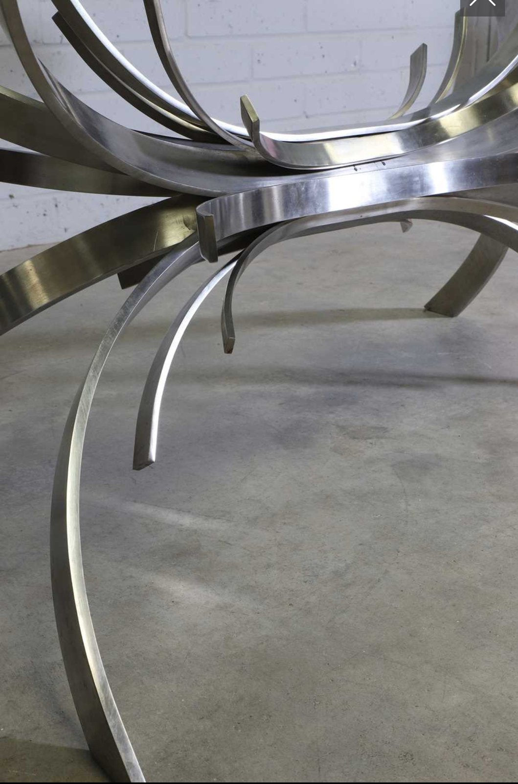 Close-up of stainless steel blades meeting the floor, Gerbe table