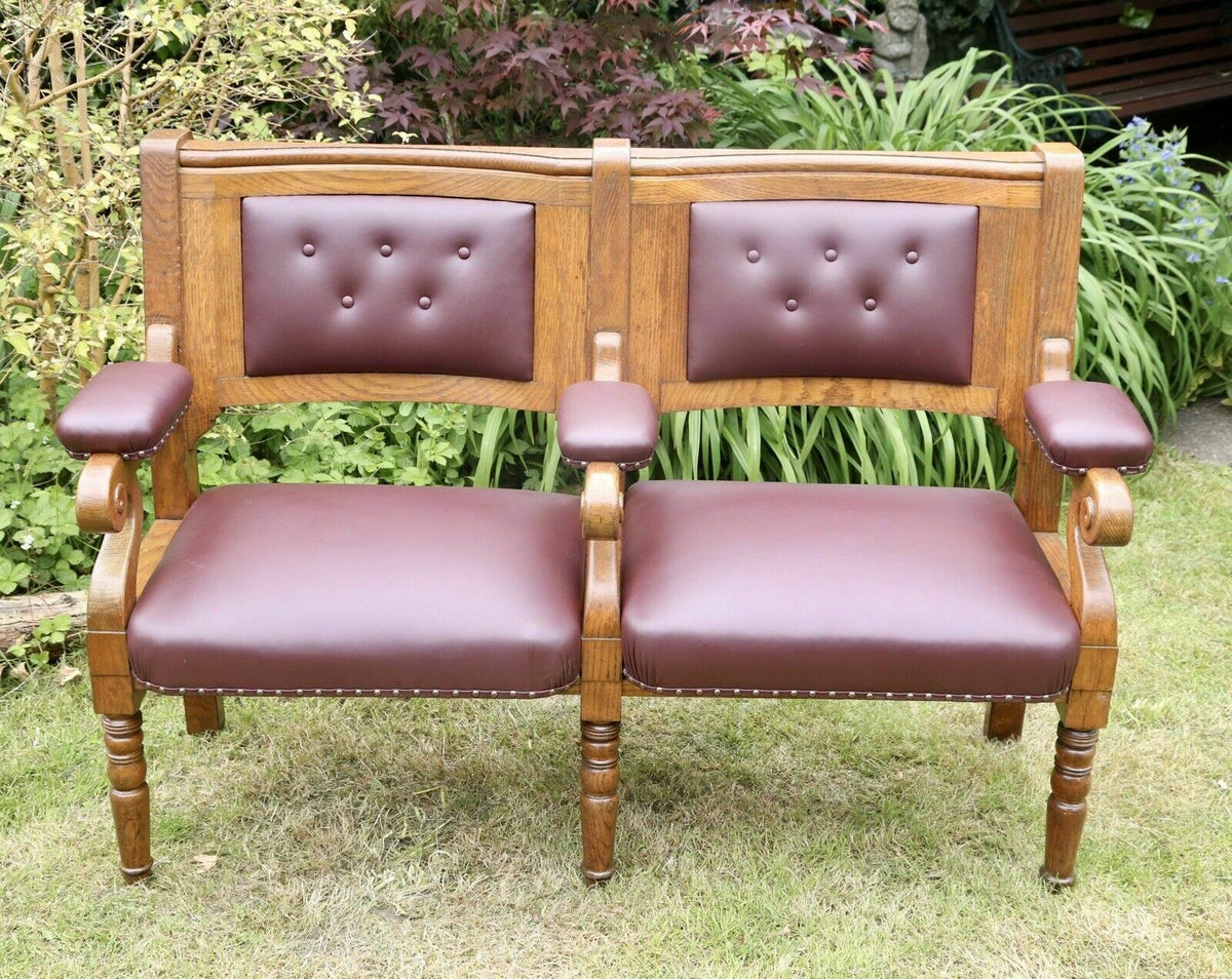 Islington Town Hall oak and burgundy leather bench, front view in a garden