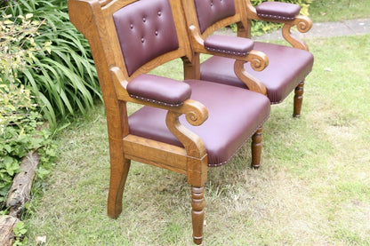Close-up of padded scroll arm and burgundy leather seat