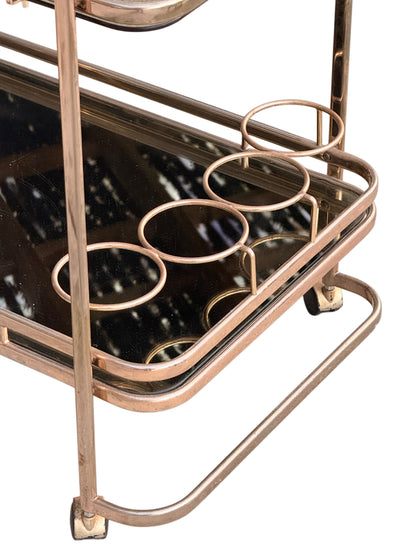 Four-ring bottle holder, looped base stretcher and castor with wear to the gilt plating