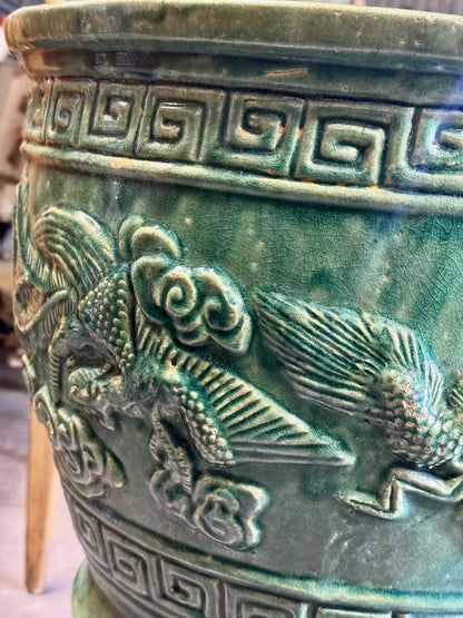 Close-up of relief phoenix bird on the emerald green jardinière
