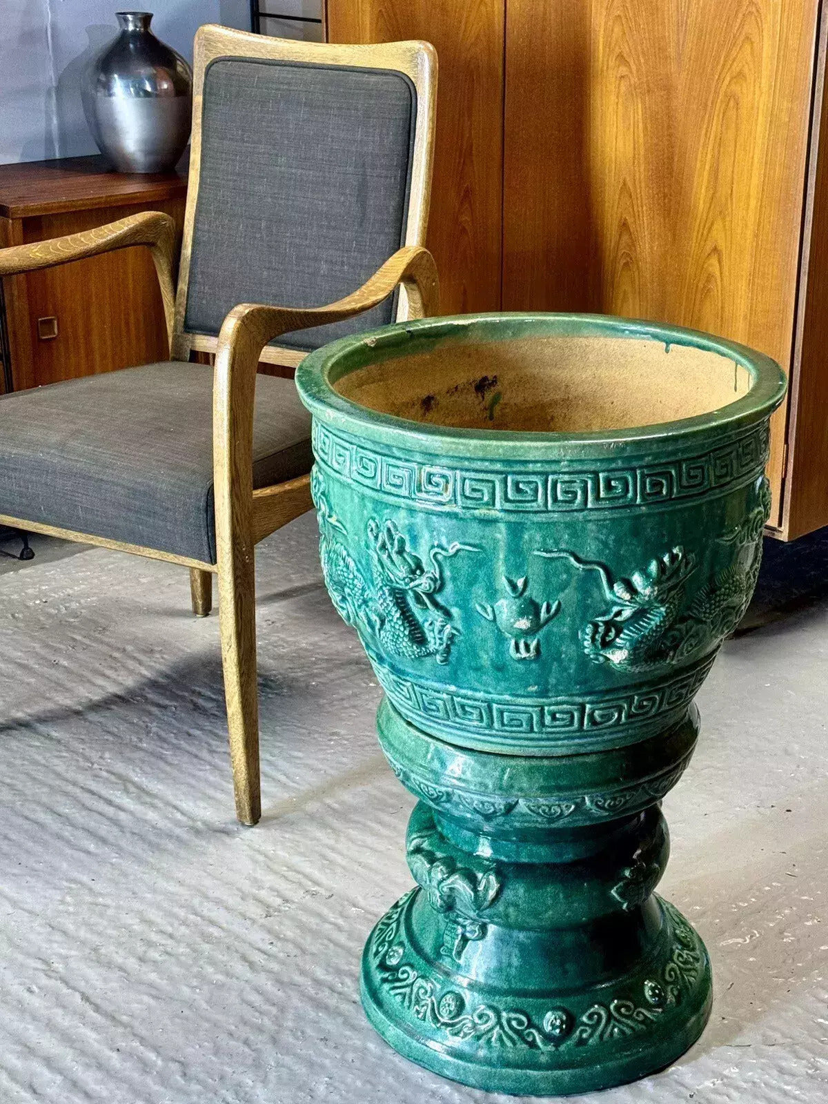 Large Chinese emerald green glazed ceramic jardinière on pedestal with relief dragons and Greek key borders