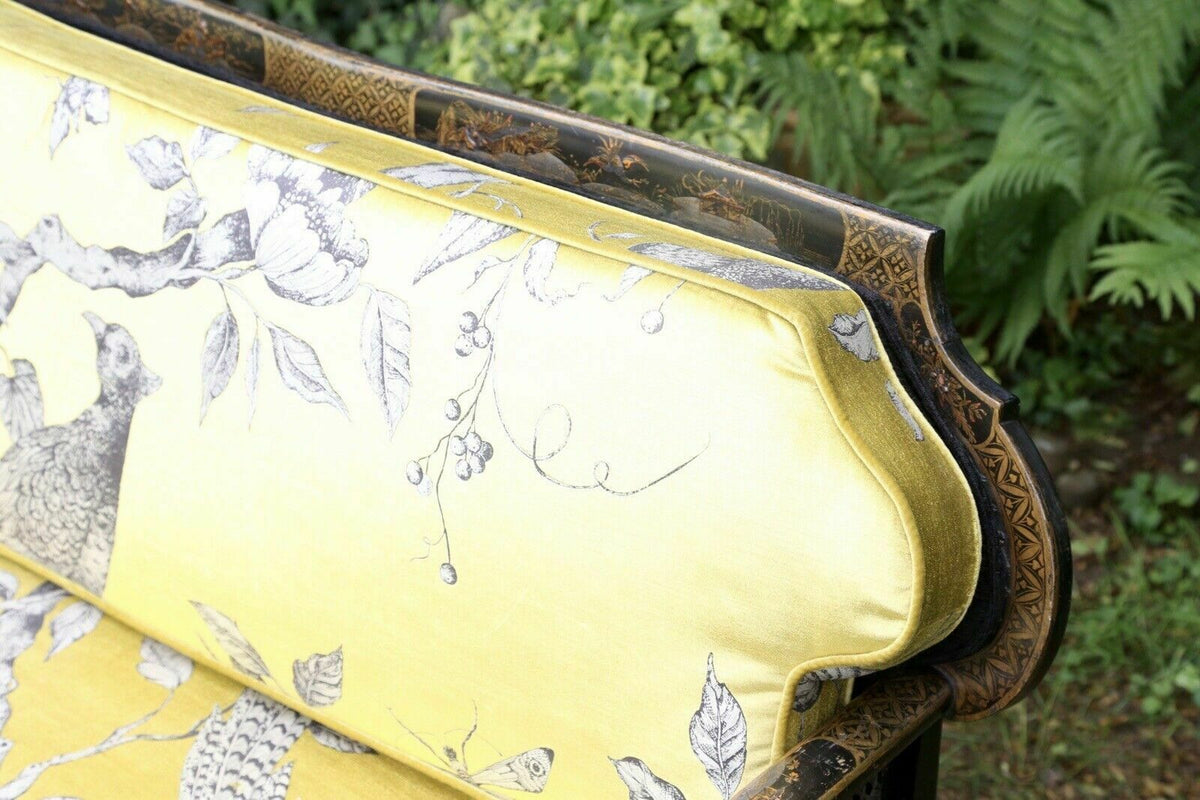 Close-up of yellow bird-print back cushion and lacquered frame