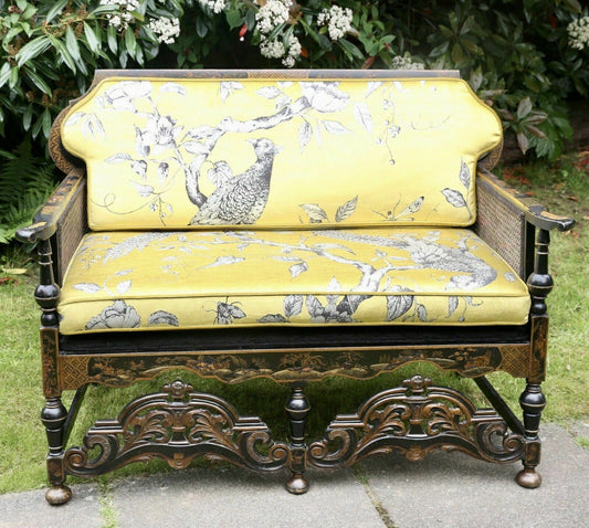 Liberty of London style 2 seater sofa, black lacquer with gilt chinoiserie, caned sides and yellow bird-print cushions