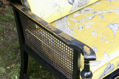 Close-up of caned side and black lacquered arm, chinoiserie sofa