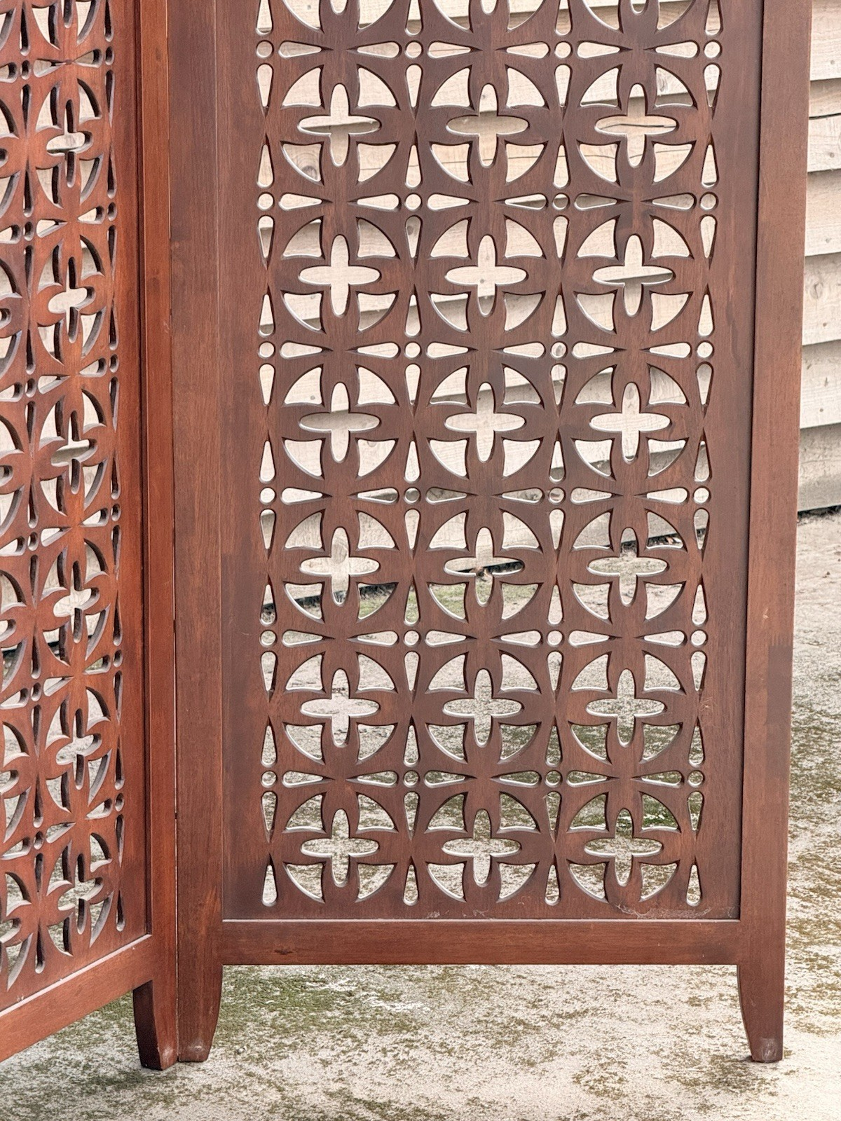 Close-up of a single pierced teak panel, side view