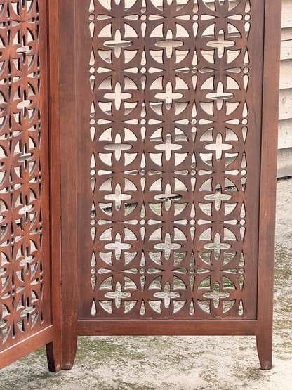 Close-up of a single pierced teak panel, side view