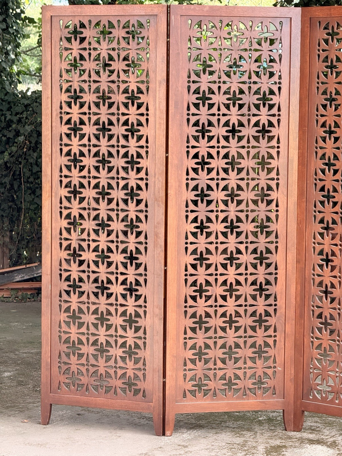 Close-up of pierced teak panels in sunlight