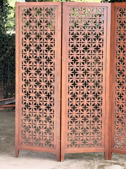 Close-up of pierced teak panels in sunlight