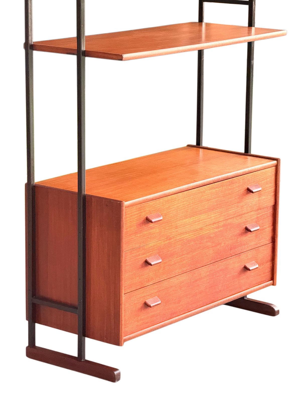Mid-century teak chest of drawers and bottom shelf on black metal uprights, three-quarter view