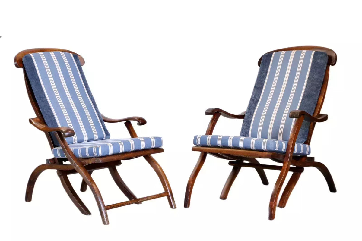 Pair of walnut steamer chairs with striped cushions, studio view