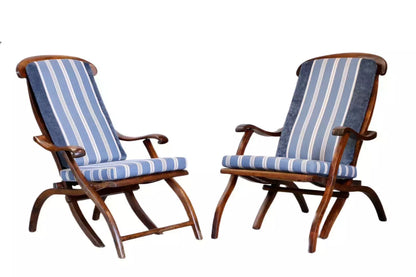 Pair of walnut steamer chairs with striped cushions, studio view