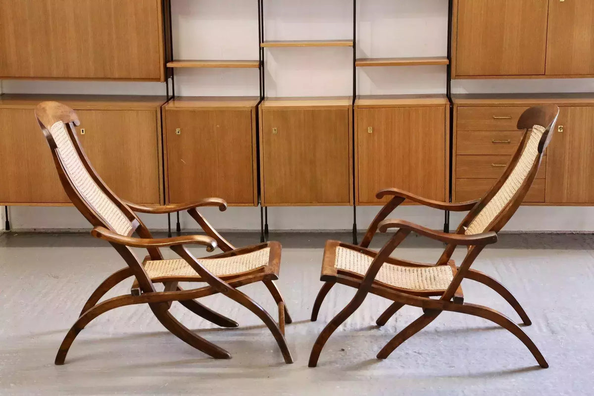 Pair of Victorian walnut steamer chairs in a room
