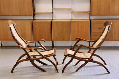 Pair of Victorian walnut steamer chairs in a room