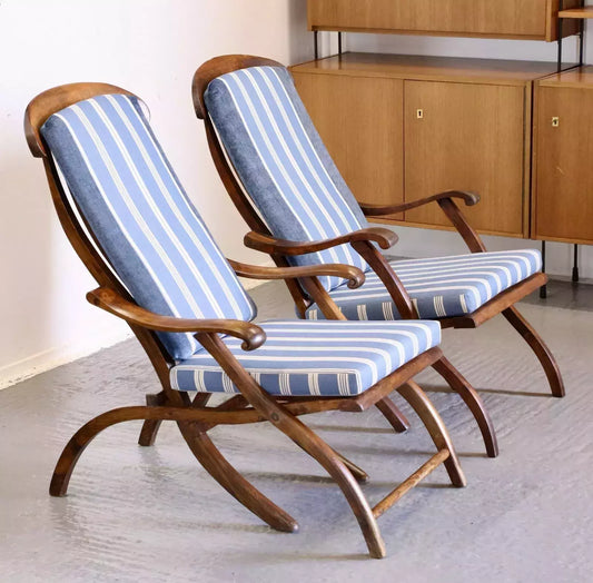 Pair of walnut steamer chairs with blue and white striped cushions
