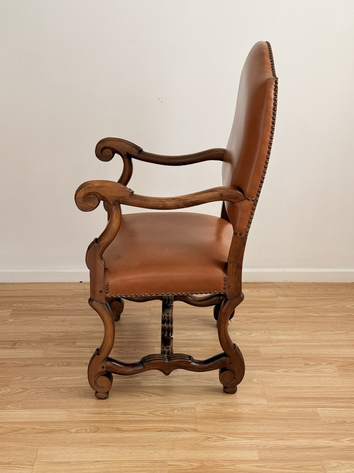 Spanish Baroque Revival carved wood and leather armchair, side profile