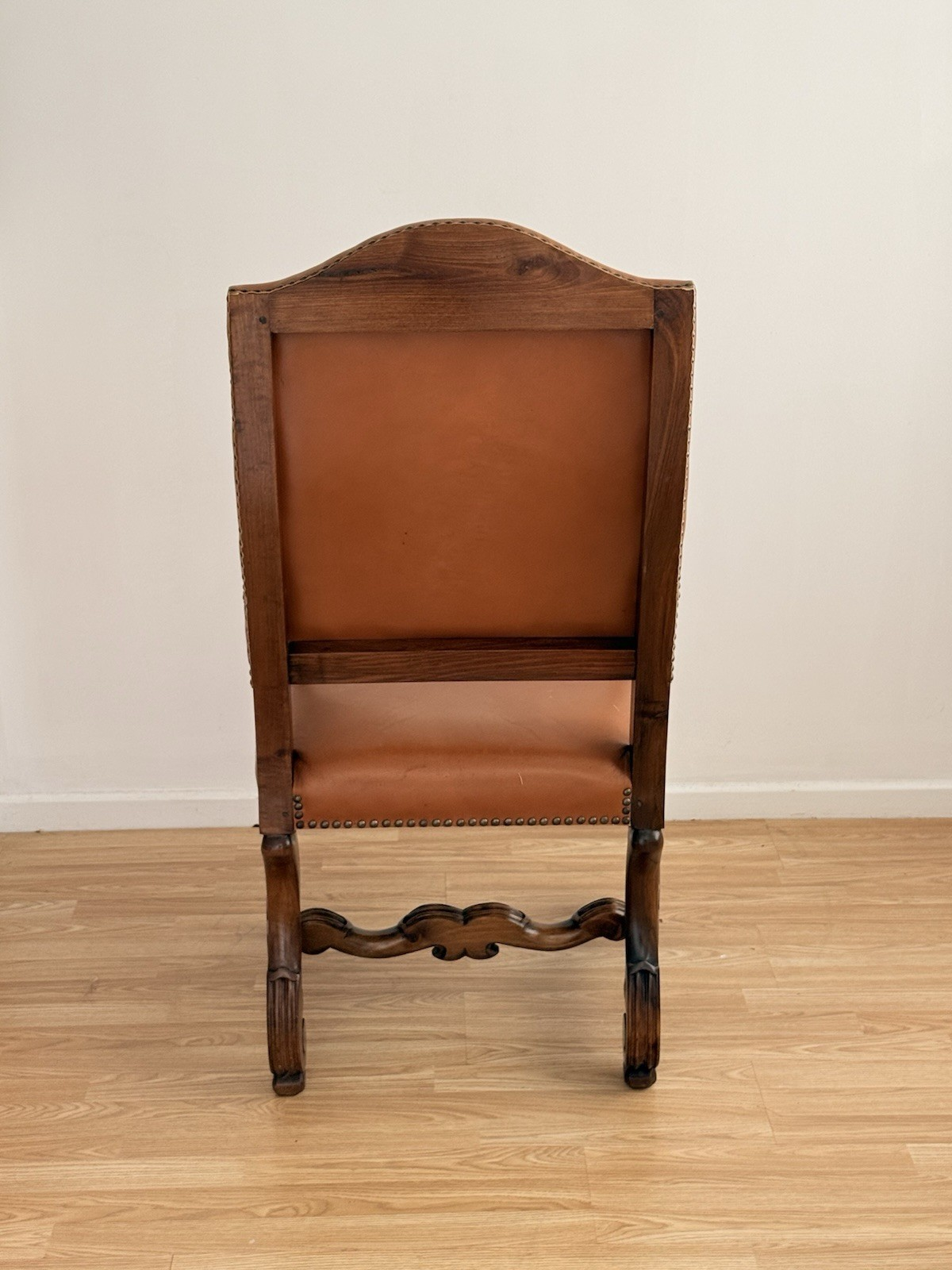 Back view of the Spanish Baroque Revival carved wood and leather armchair