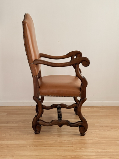 Spanish Baroque Revival carved wood and leather armchair, side view showing carved stretcher
