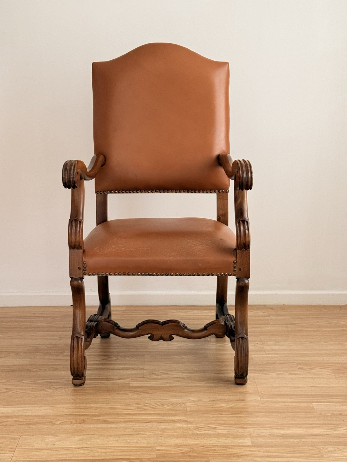 Spanish Baroque Revival carved wood and leather armchair, front view
