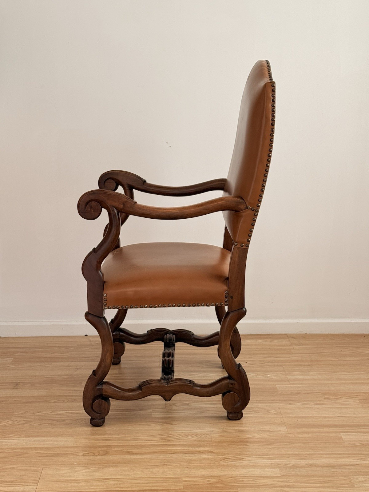 Spanish Baroque Revival carved wood and leather armchair, left side profile