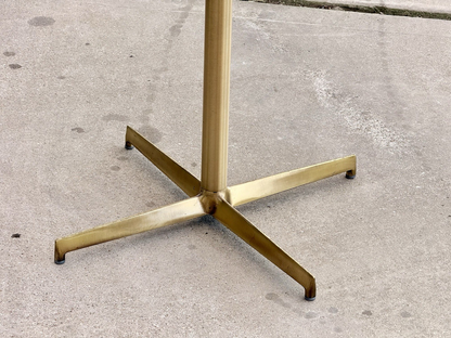 Close-up of antique brass four-star base, Pedrali side table