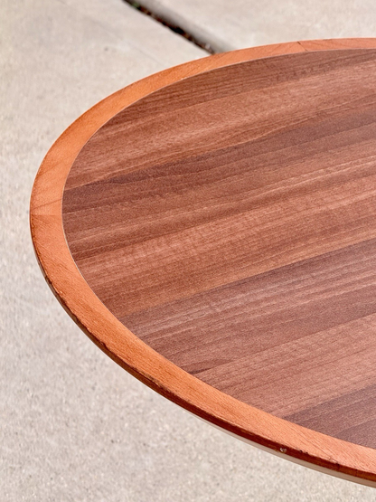 Close-up of raised edge on the round mahogany finish top
