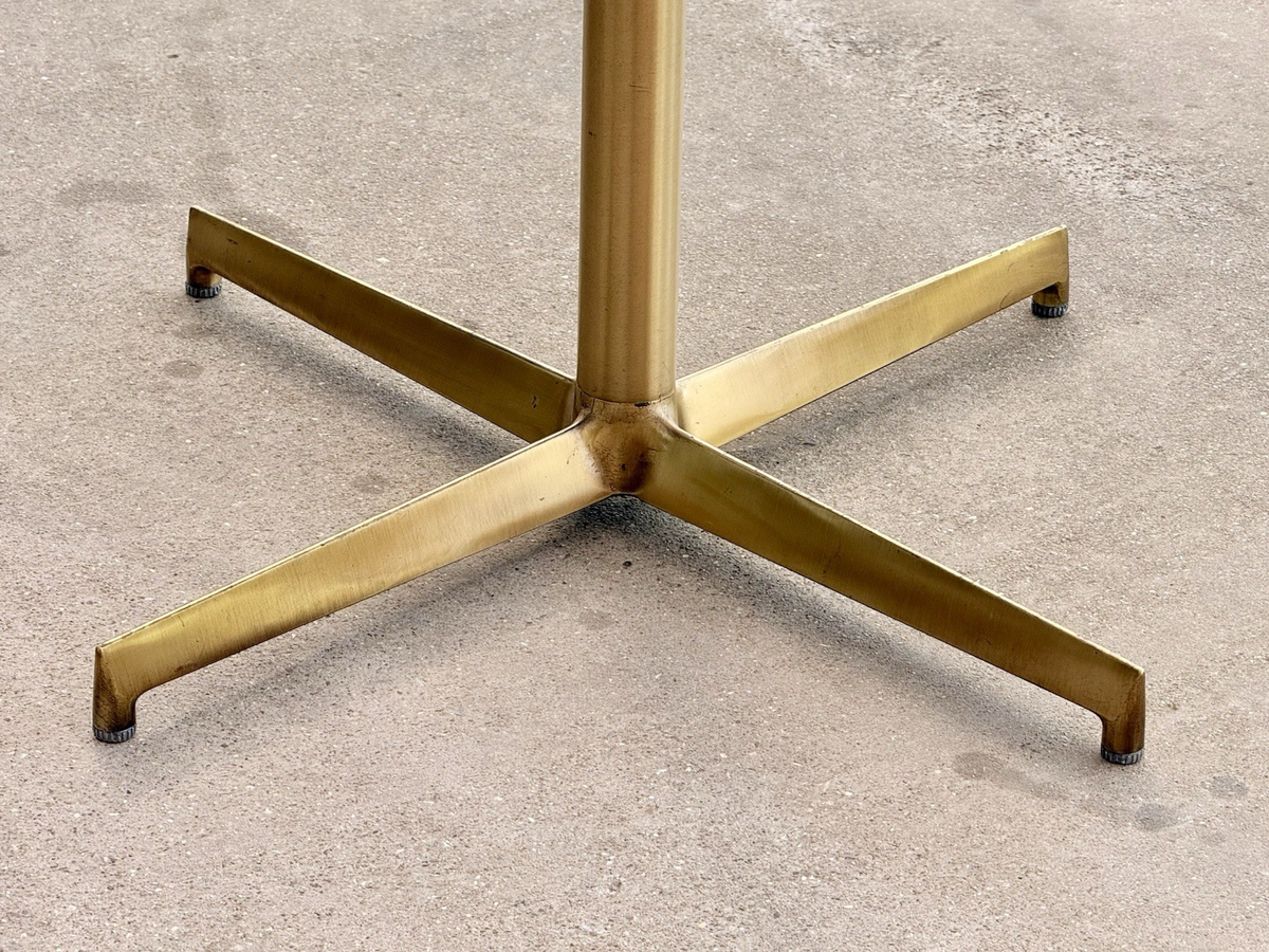 Close-up of brass X base and column, Pedrali table