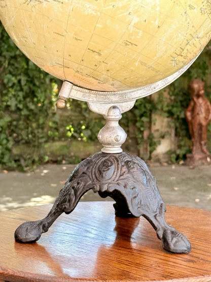 Close-up of the ornate cast iron tripod base, Philips globe