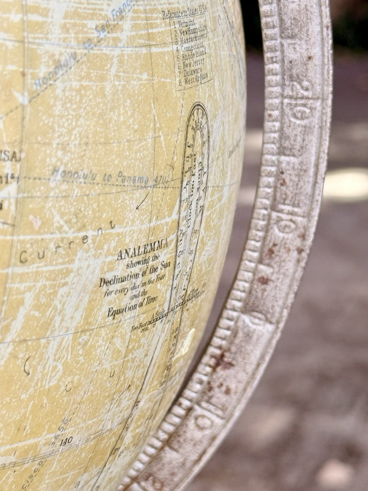 Close-up of graduated metal meridian ring and paper gores