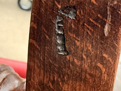 Close-up of stamped mark on the wooden frame underside