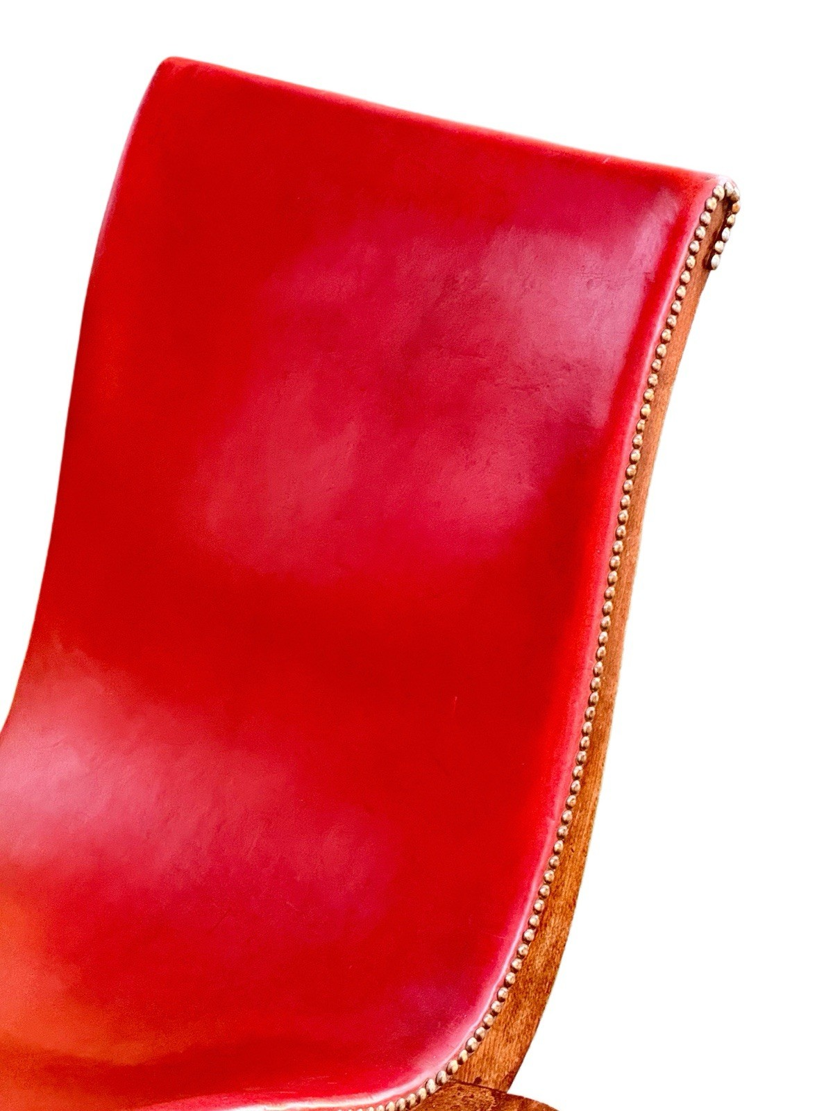 Close-up of red leather back and brass nailhead edge