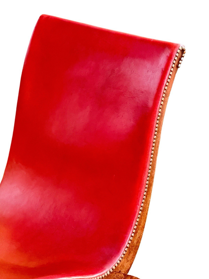 Close-up of red leather back and brass nailhead edge