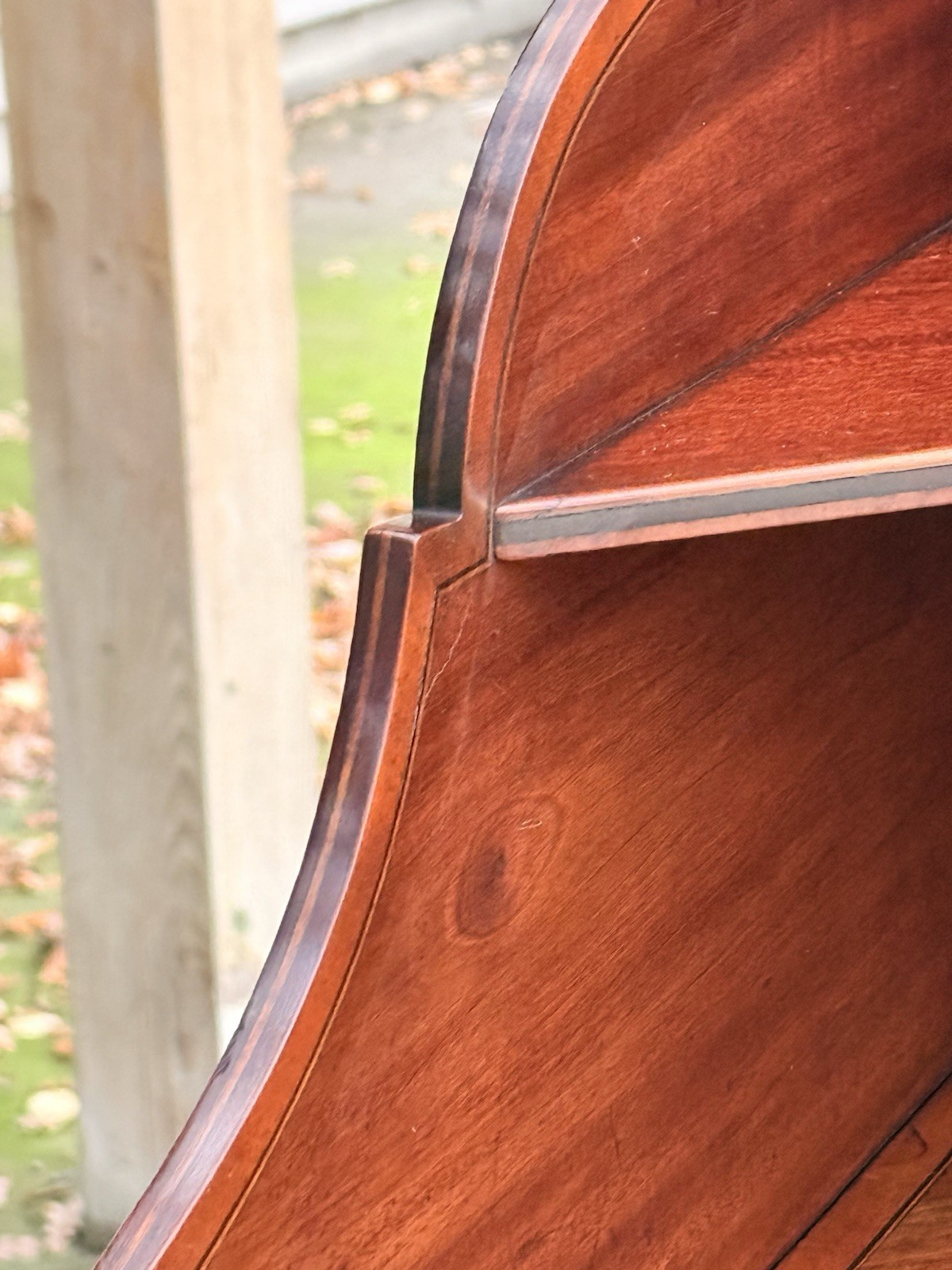 Close-up of mahogany shelf and shaped back