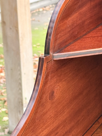 Close-up of mahogany shelf and shaped back