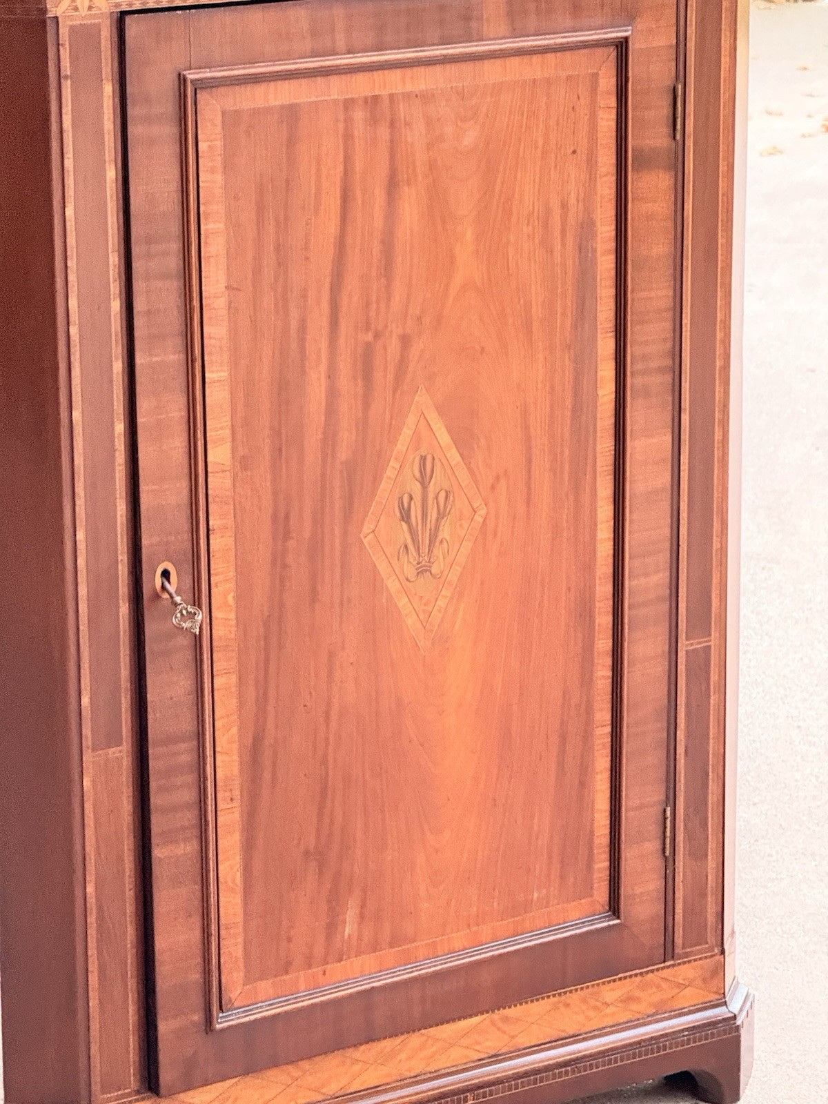 Close-up of the inlaid lozenge door panel and brass lock