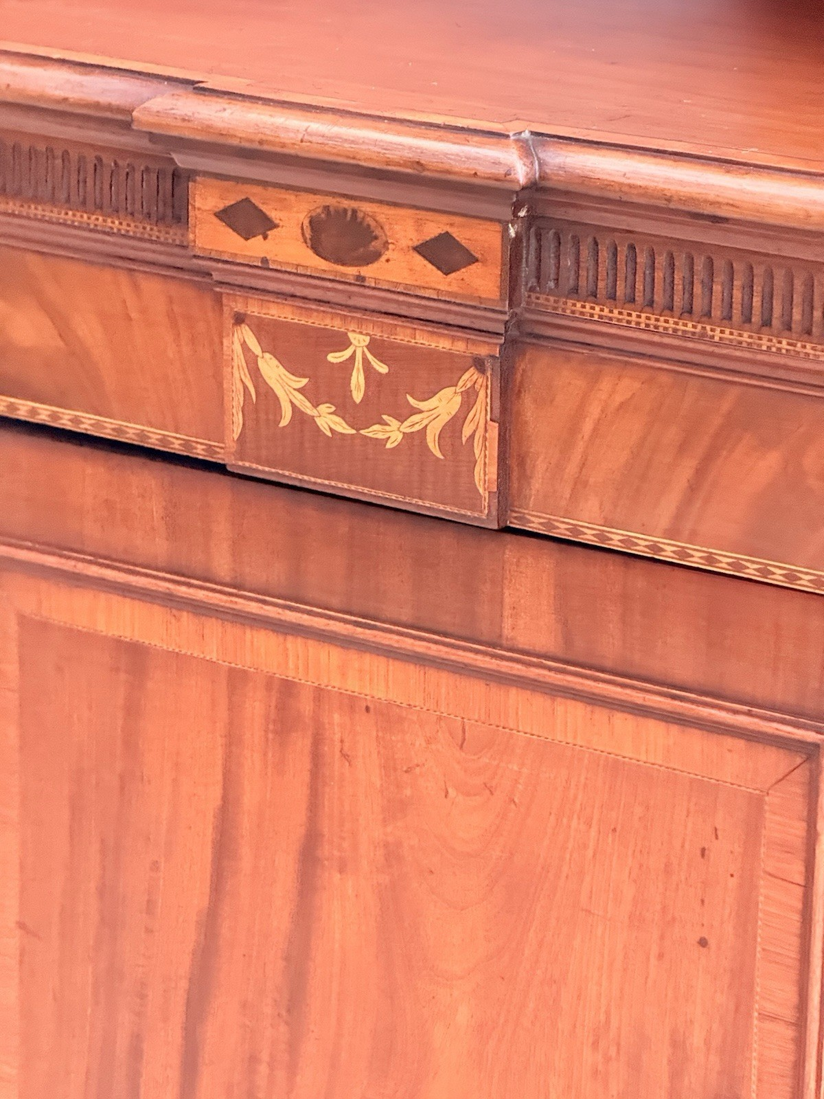 Close-up of satinwood inlaid swag and paterae frieze