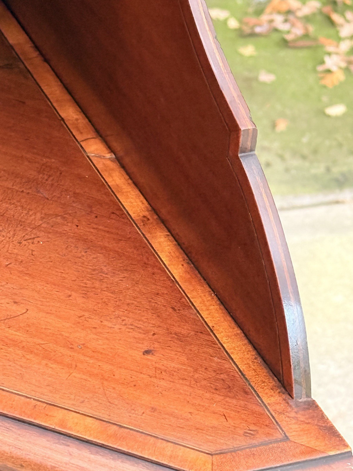 Close-up of shaped and shelved upper back of the corner cabinet