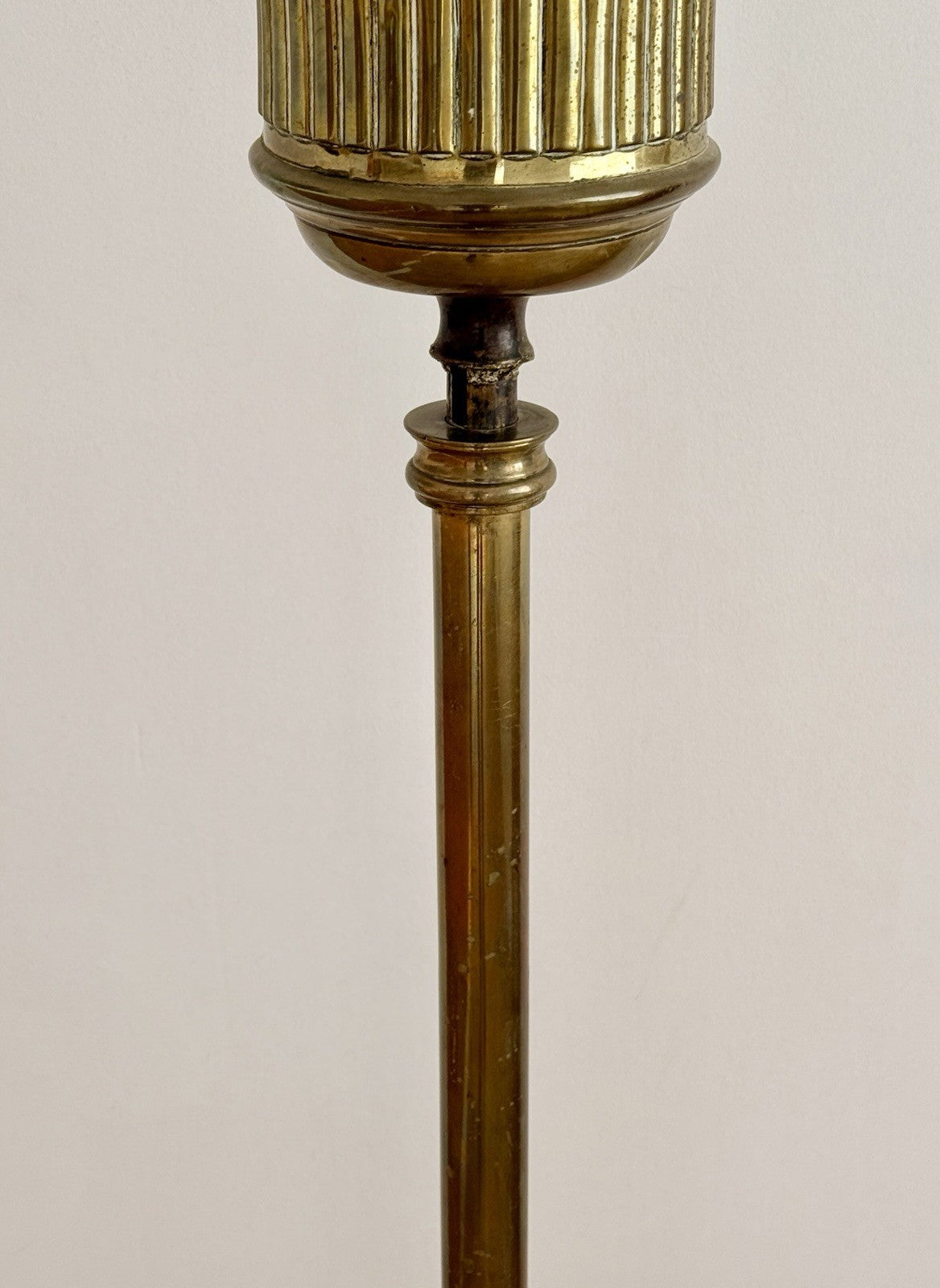Close-up of brass stem below the fluted urn