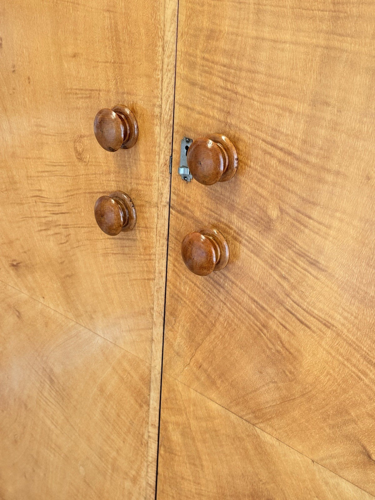 Close-up of figured bird's eye maple veneer and knobs