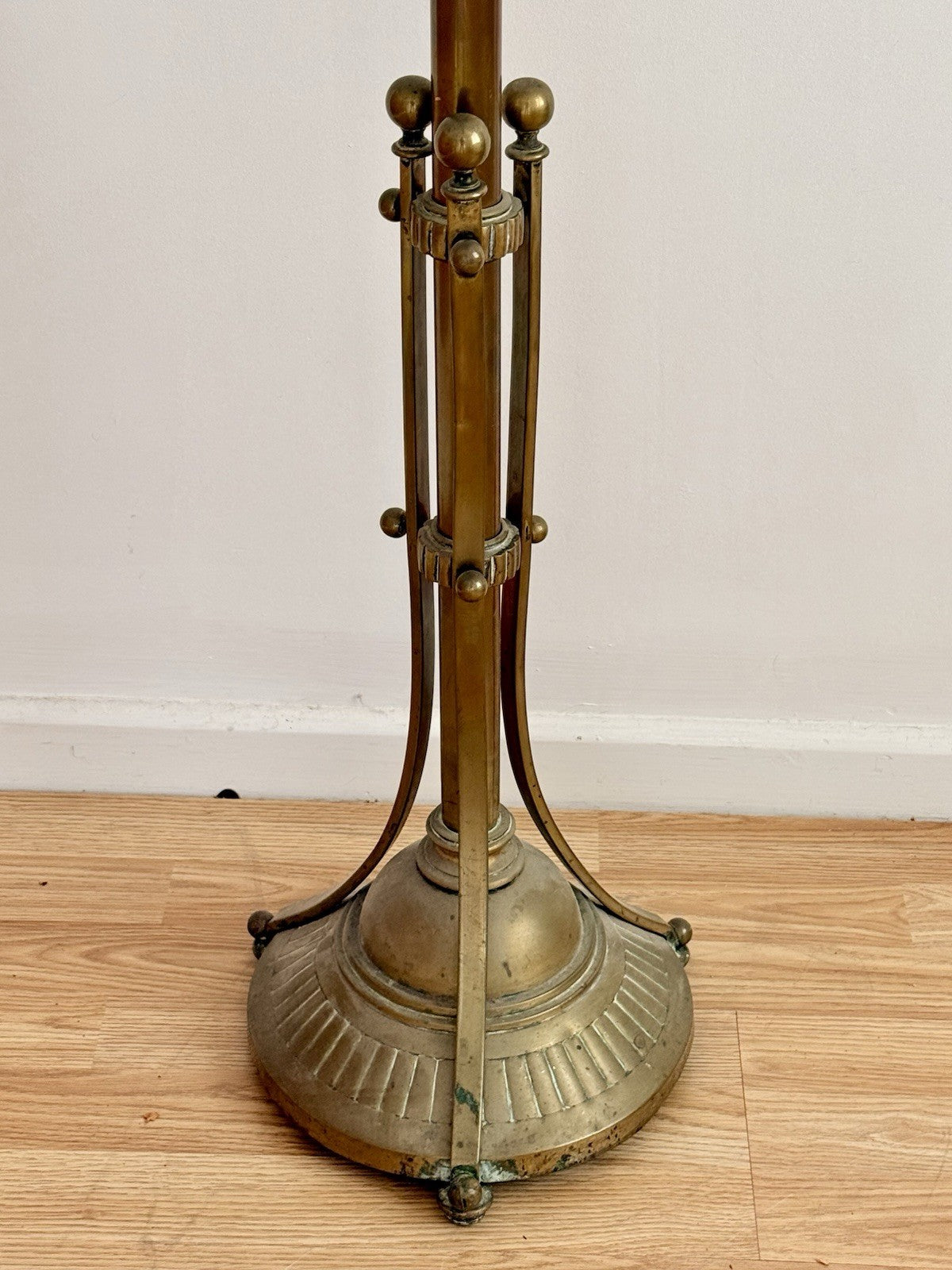 Close-up of brass tripod base with fluted foot, Hine & Co lamp