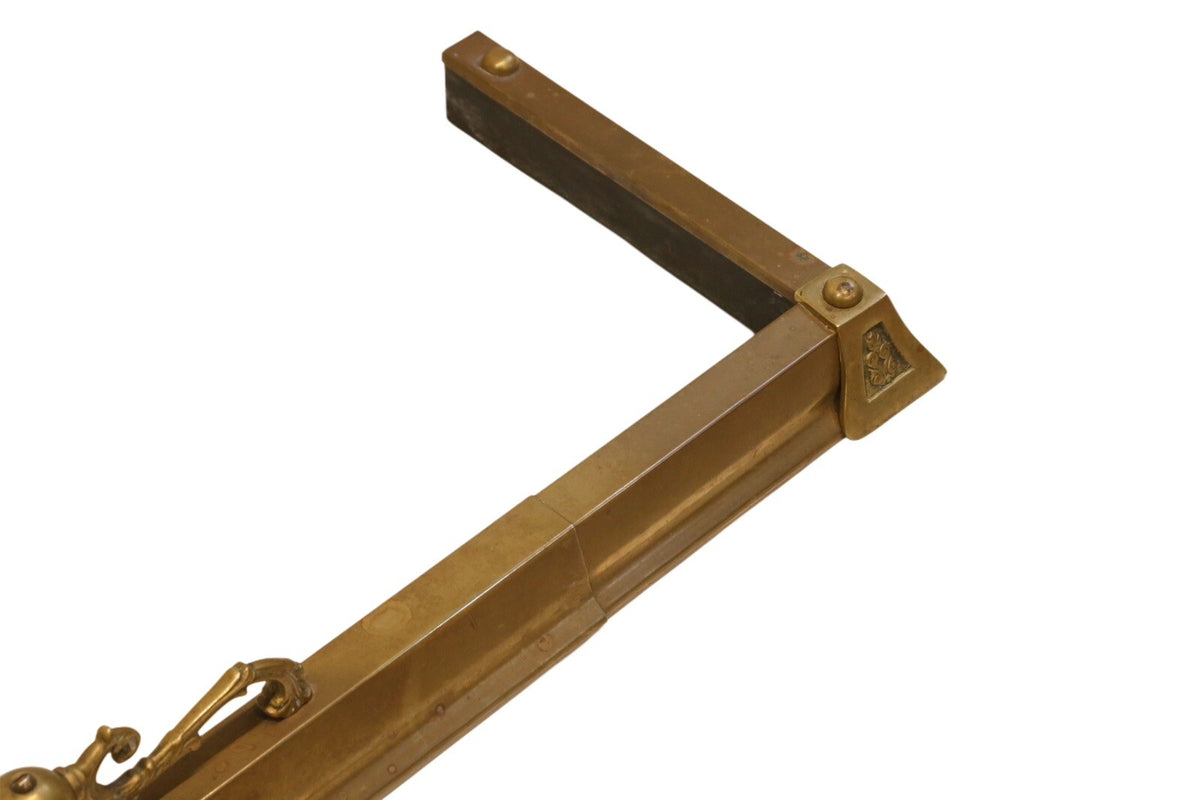 Close-up of a corner of the brass fireplace fender
