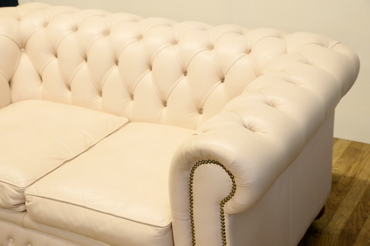 Cream Chesterfield sofa, detail of arm and seat cushions