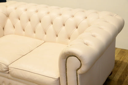 Cream Chesterfield sofa, detail of arm and seat cushions