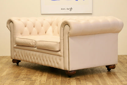 Cream leather Chesterfield 2 seater sofa, three-quarter view from the right