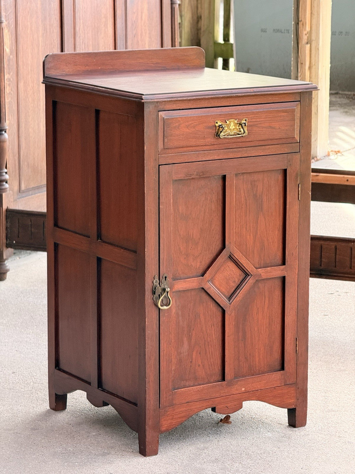 Arts & Crafts mahogany side cabinet, three-quarter view outdoors