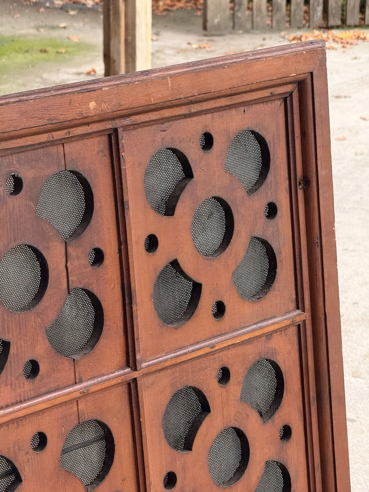 Close-up of carved pine frame and quatrefoil pierced panel