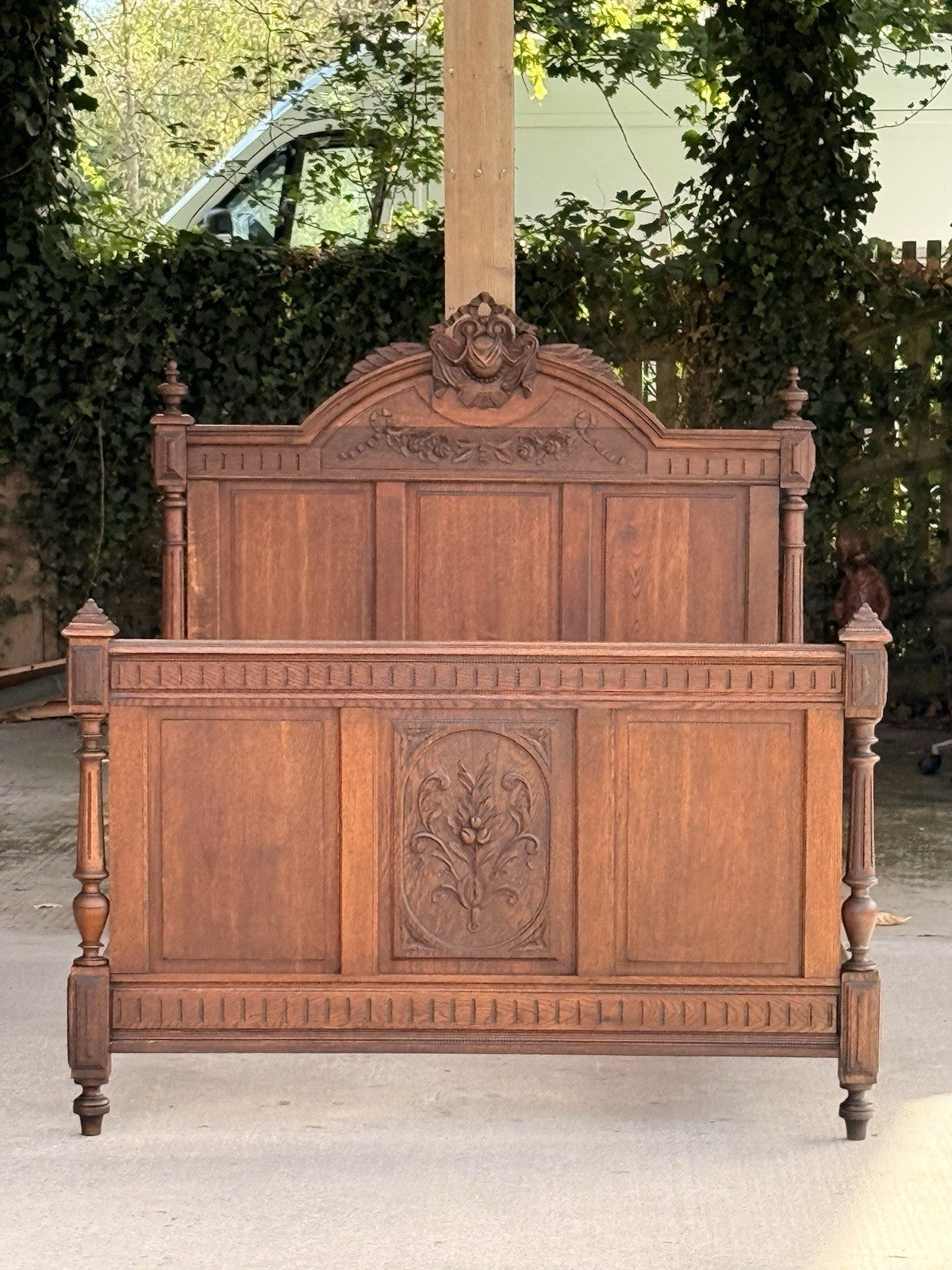 Antique French oak Henri II bed, headboard and footboard front view